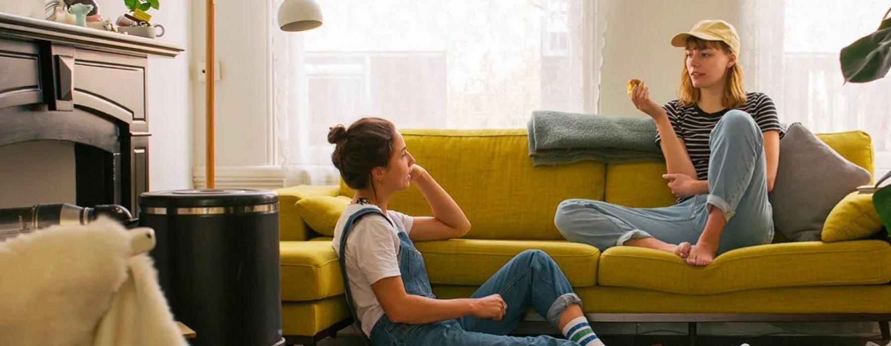 a person and a girl sitting on a couch